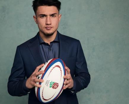 Rugby player Marcus Smith holds rugby ball for Charles Tyrwhitt photo shoot