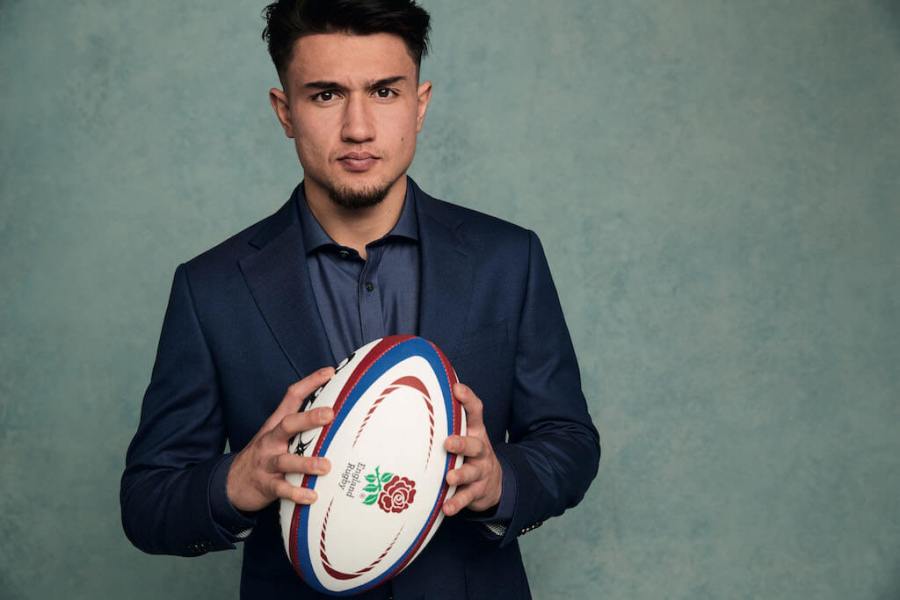 Rugby player Marcus Smith holds rugby ball for Charles Tyrwhitt photo shoot