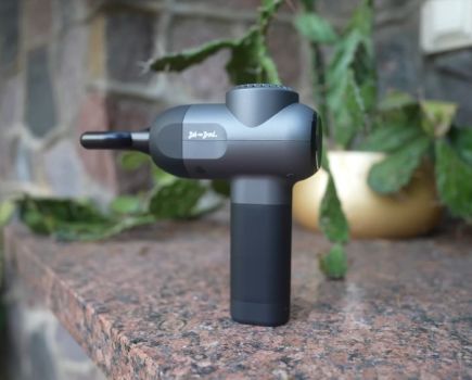 The Bob and Brad C2 Massage Gun in a garden