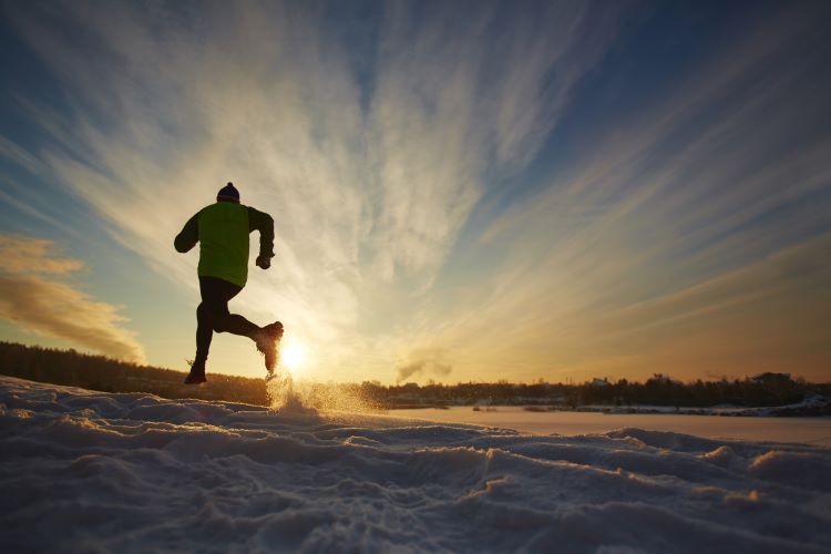 Man running in winter countryside