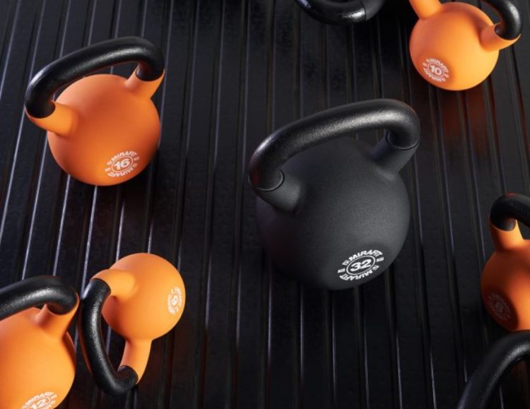 A selection of black and orange Mirafit kettlebells