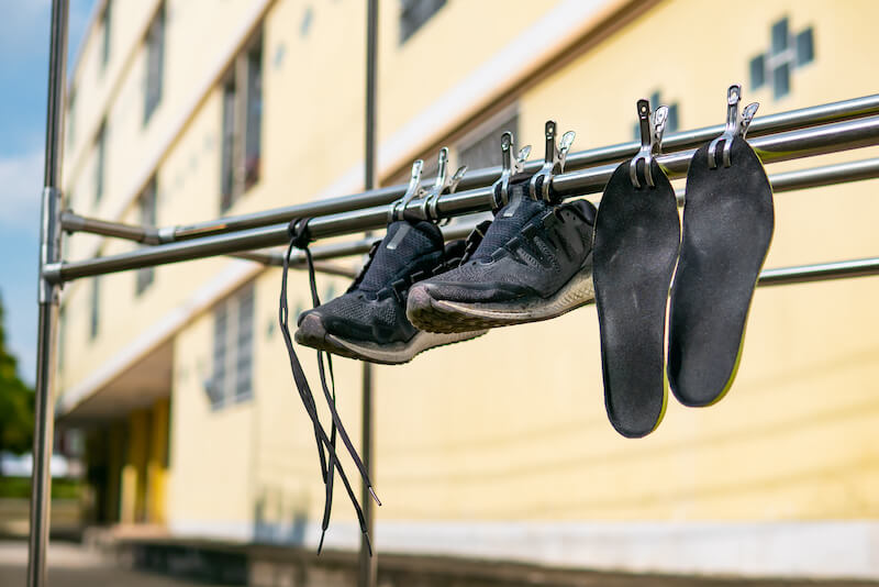 Gym shoes and insoles hanging out to dry on a washing line