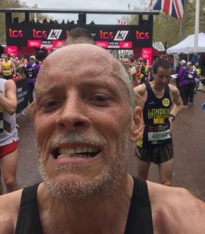 A grimacing marathon runner at the end of the London Marathon