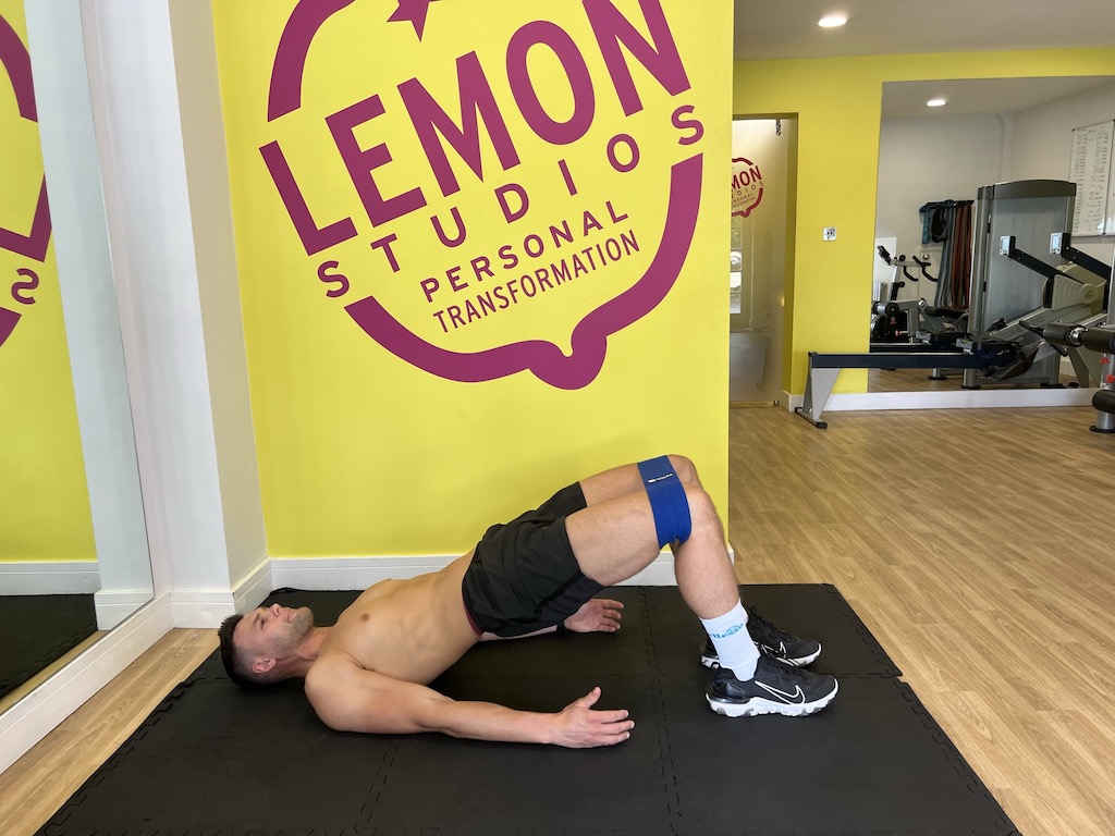 man performing banded hip thrust