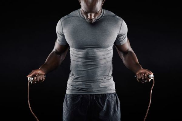 Close up of a man working out with a skipping rope