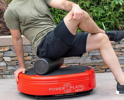 Mid torso shot of a man exercising on a vibration plate