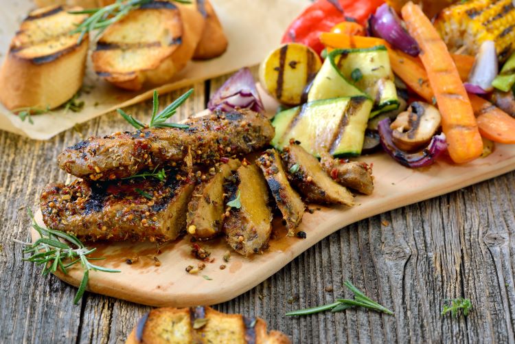 Seitan vegan steak and vegetables on a chopping board