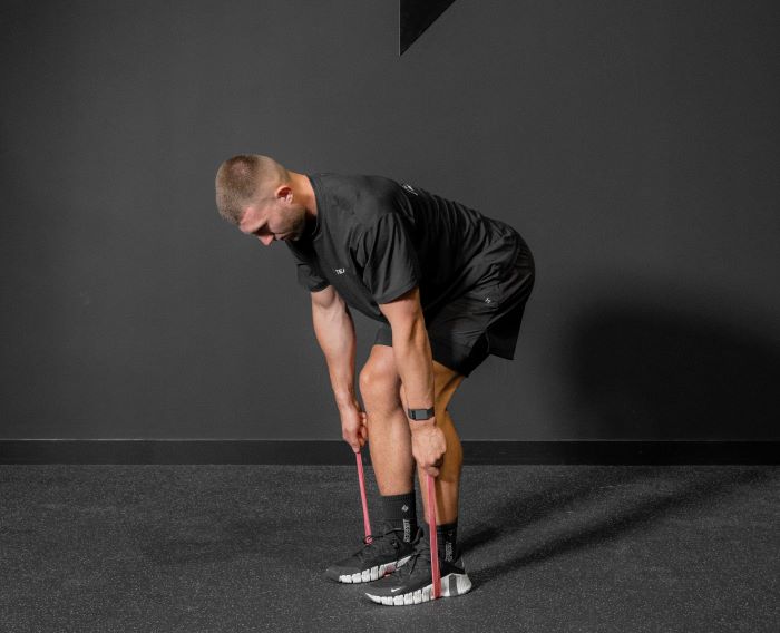 Man performing a resistance band bent over row