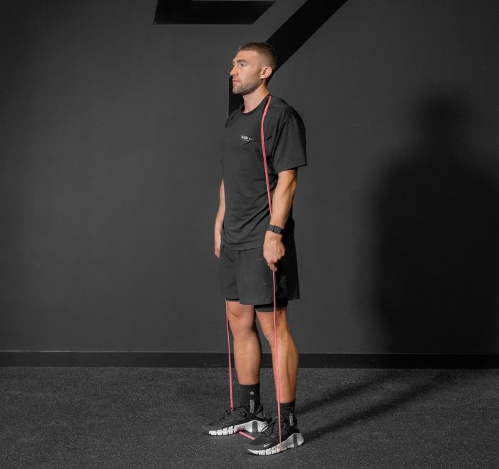 Man performing a resistance band deadlift