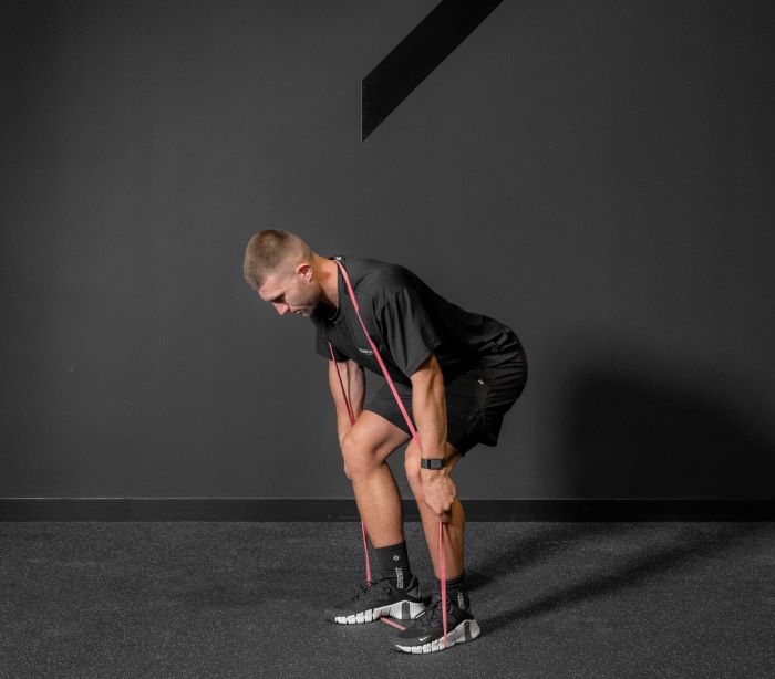 Man performing a resistance band deadlift