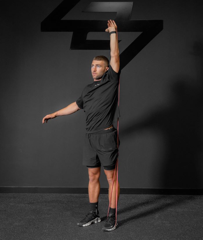 Man performing a resistance band shoulder press