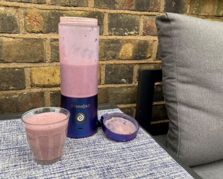 BlendJet2 blender and smoothie on an outside table