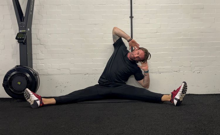 Man performing QL stretch - best back stretches