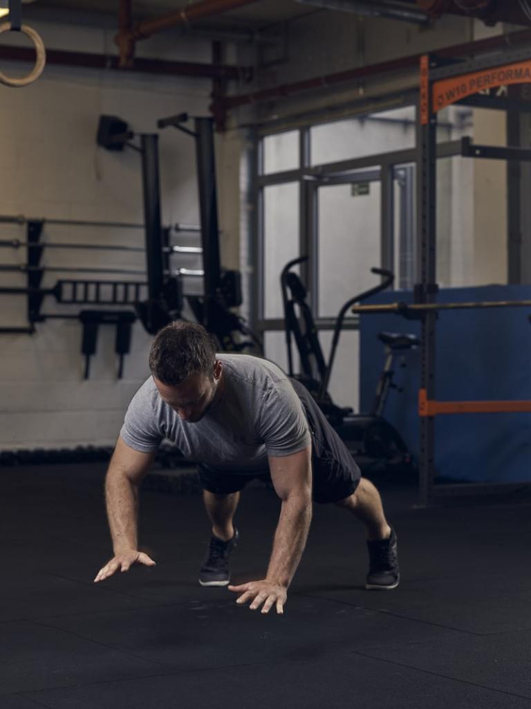 man performs ballistic press up, one of the best bodyweight exercises for building strength