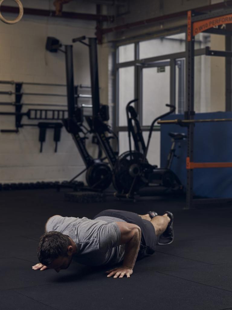 man performs part 4 of a burpee