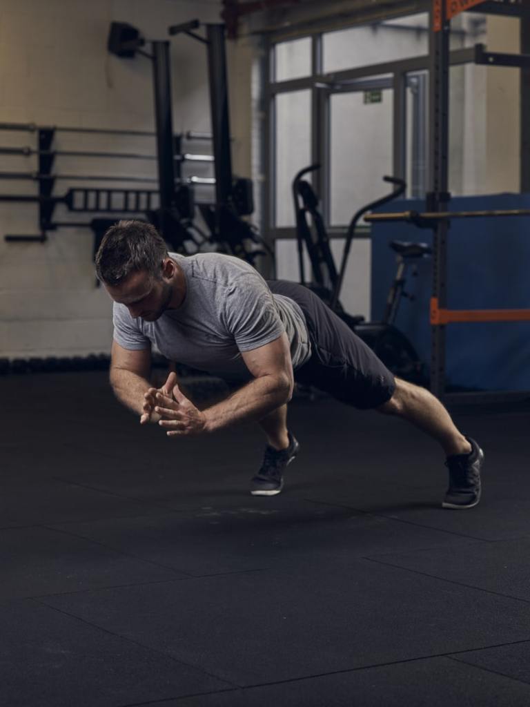 man performs clapping press up