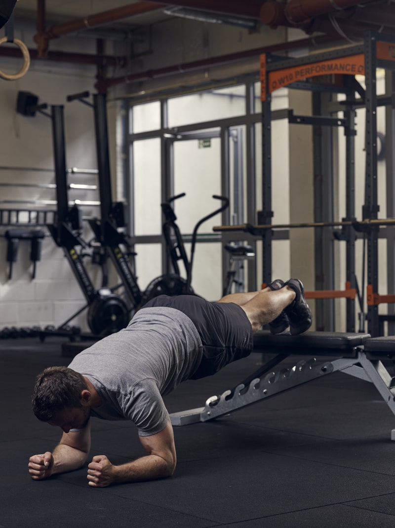 man performs decline plank, one of the best bodyweight exercises for core strength