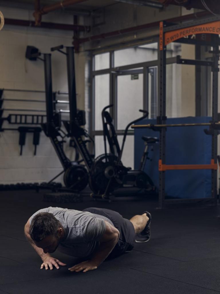 man lowers into diamond press up position, showing best bodyweight exercises