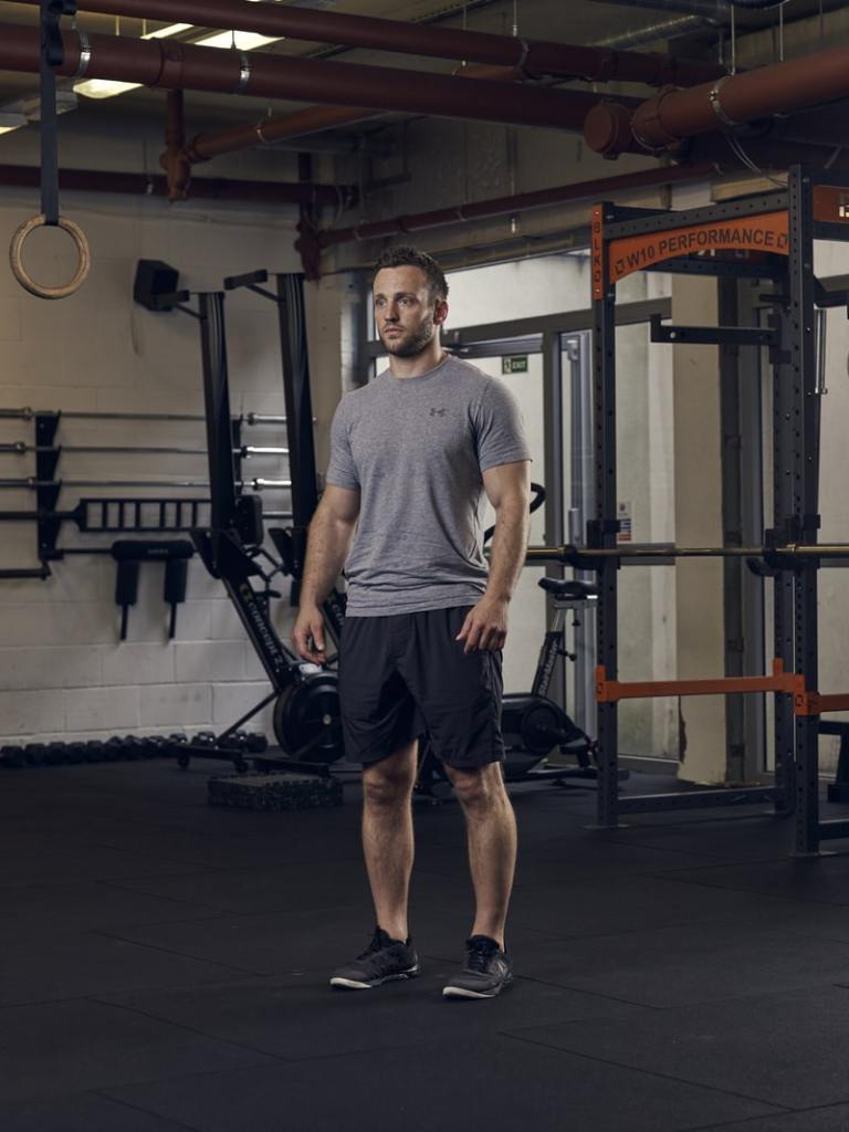 man demonstrates part 1 of half burpee