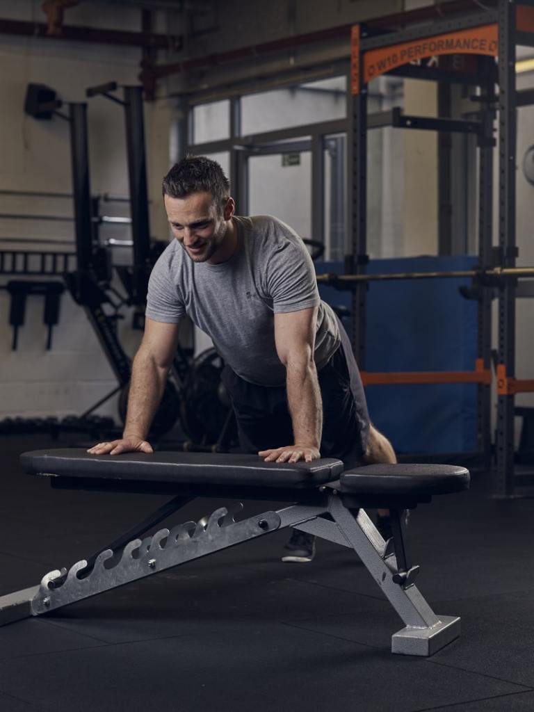 man demonstrates incline press up