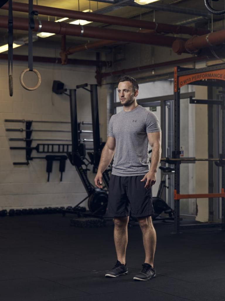 man demonstrates lunge in gym