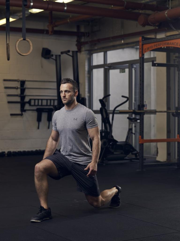 man shows how to do a lunge correctly, one of the best bodyweight exercises for building lower-body strength