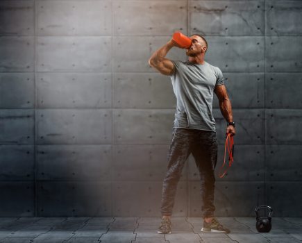 Athletic man drinking protein shake after a workout