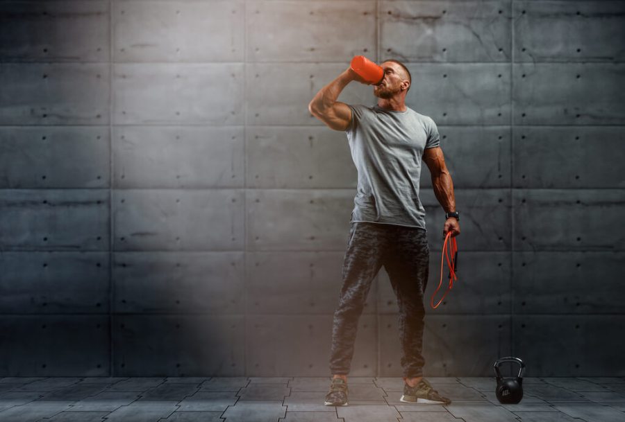 Athletic man drinking protein shake after a workout