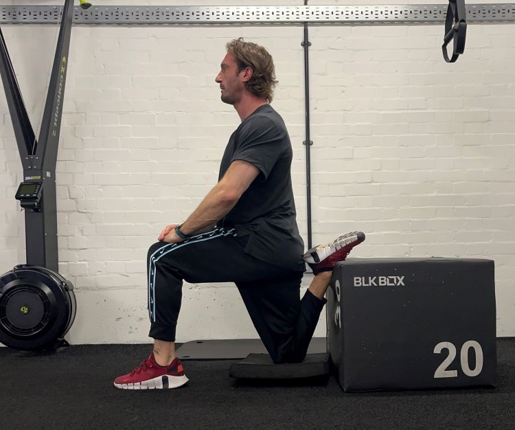 Man performing sofa stretch - best back stretches