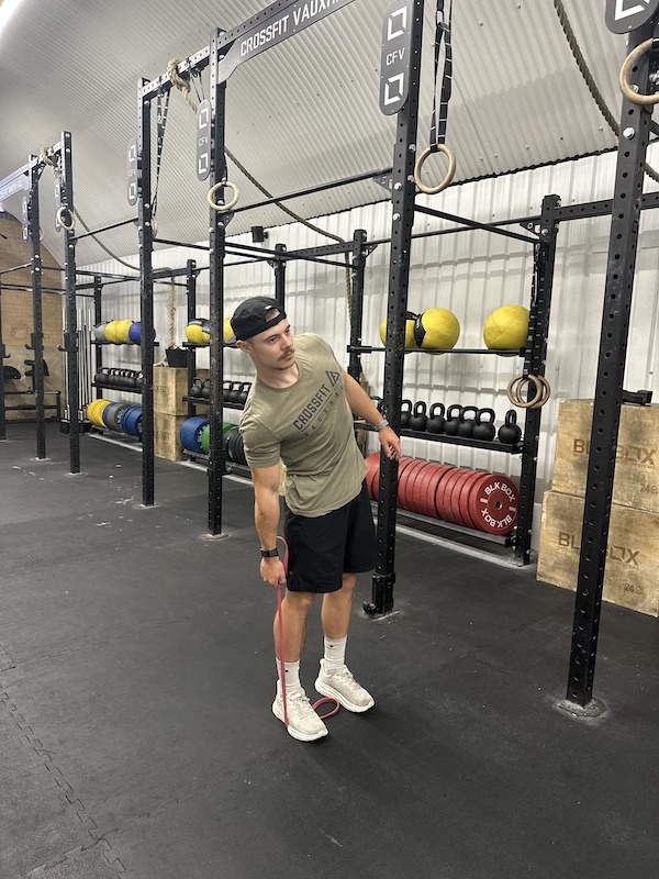 man performing band side bend abs exercise