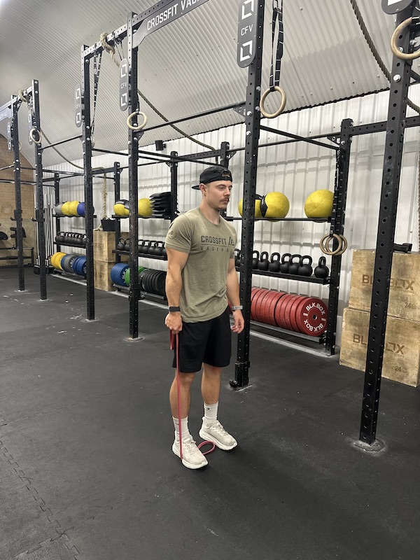 man performing band side bend abs exercise