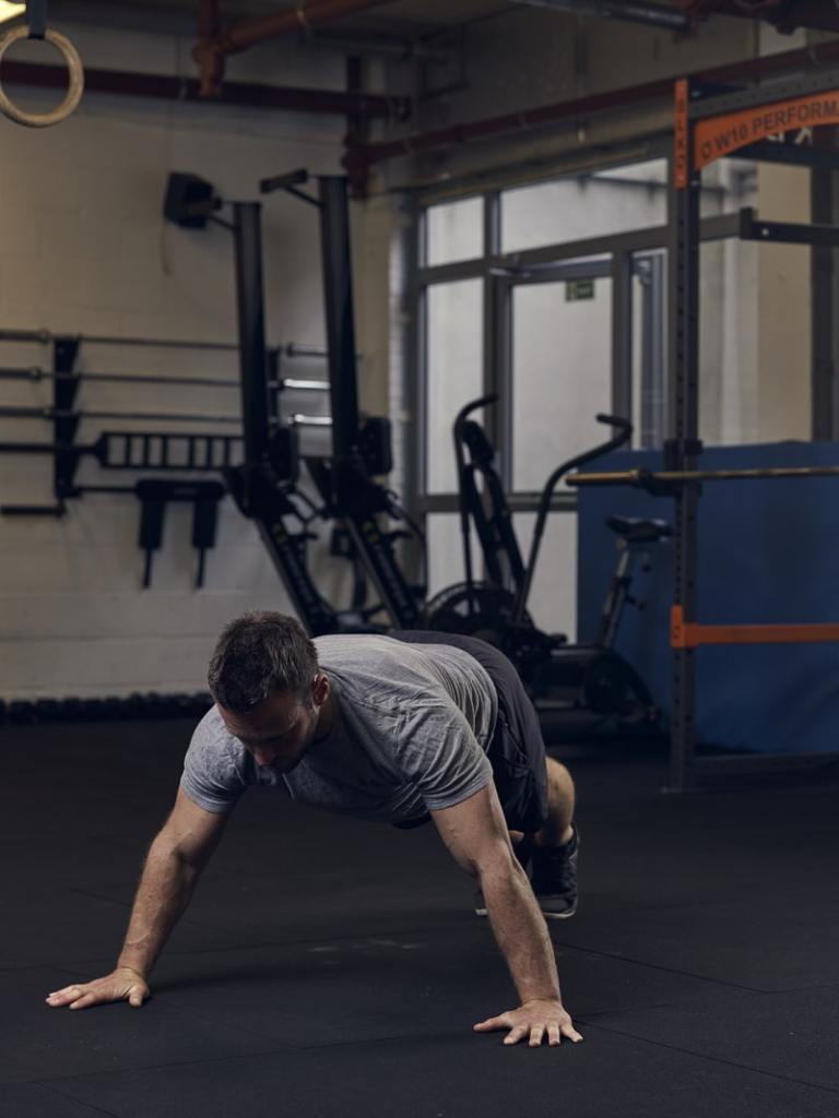 man demonstrates wide press up