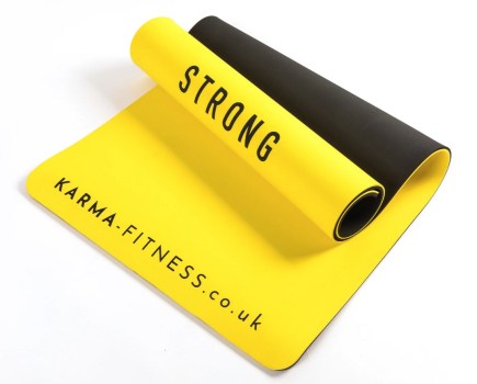 A partially rolled up yellow exercise mat