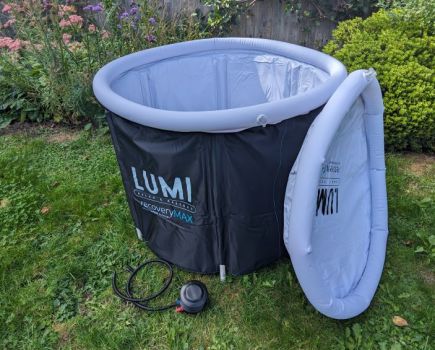 A portable ice bath set up in a garden