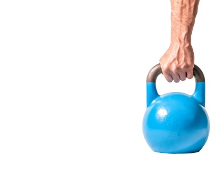 man's hand gripping the handle of a blue kettlebell