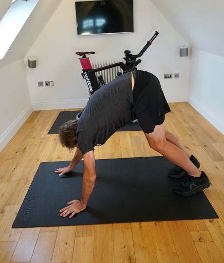 Man in home gym performing yoga poses