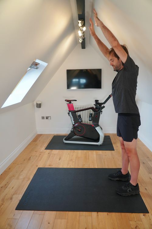 Man in home gym performing yoga poses