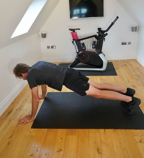 Man in home gym performing yoga poses