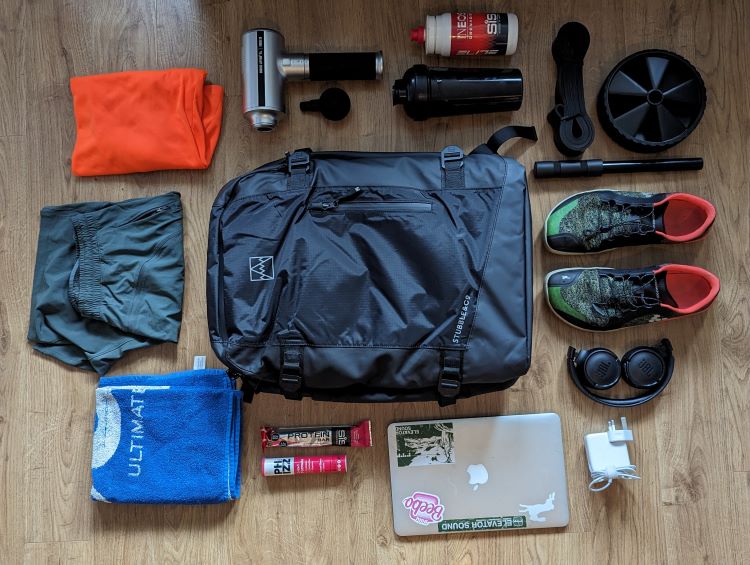 Overhead shot of gym bag surrounded by gymwear and equipment