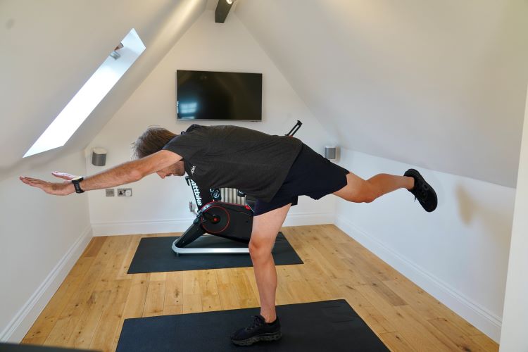 Man performing stretches in home gym