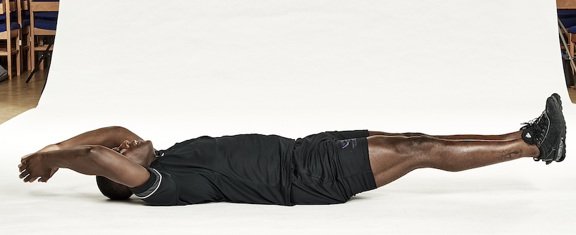 Man in black shorts and black training top performing