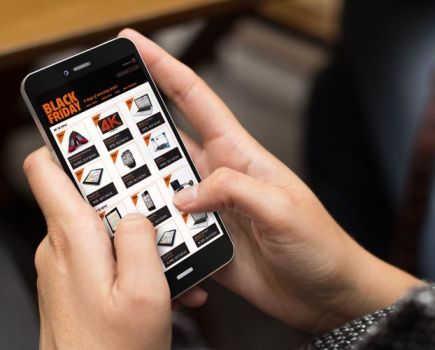 Close up of a man shopping on his phone for Black Friday deals