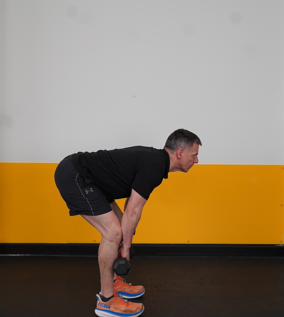 man performing dumbbell deadlift to show how to strength train in your sixties