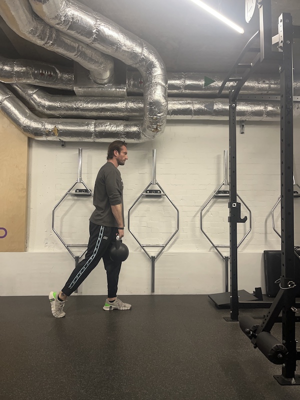 man performing kettlebell 'B stance' RDL in the gym