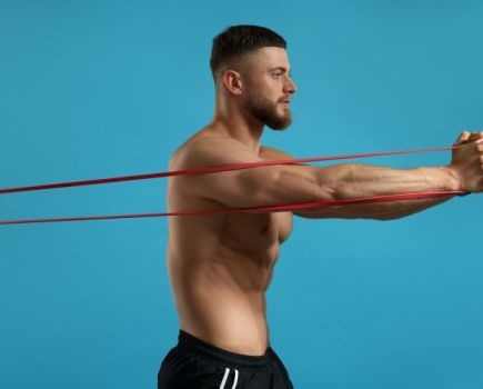 man in gym performing banded abs exercise