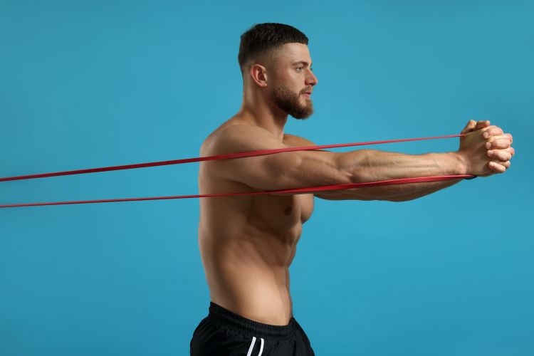 man in gym performing banded abs exercise