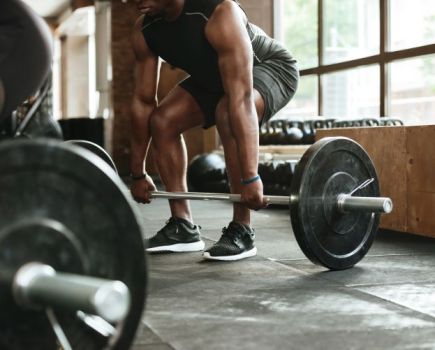 Close-up of a man lifting a barbell