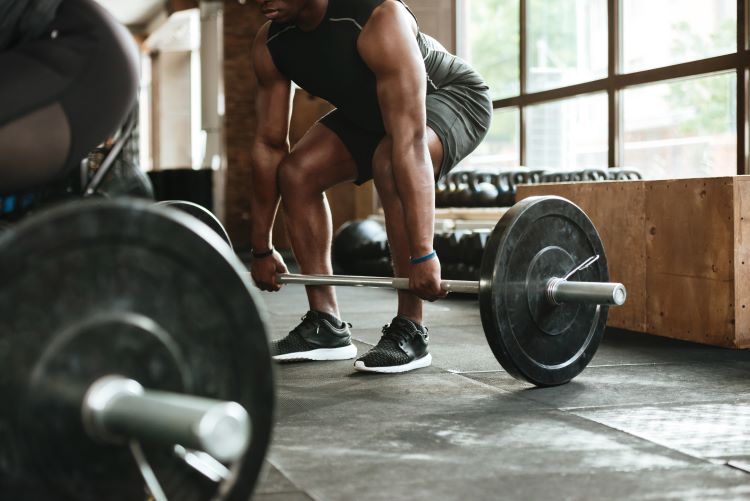 Close-up of a man lifting a barbell