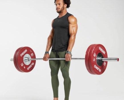 Man in compression tights lifting a barbell