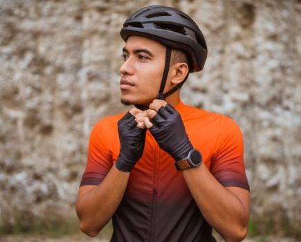 Close-up of a man doing up his cycling helmet